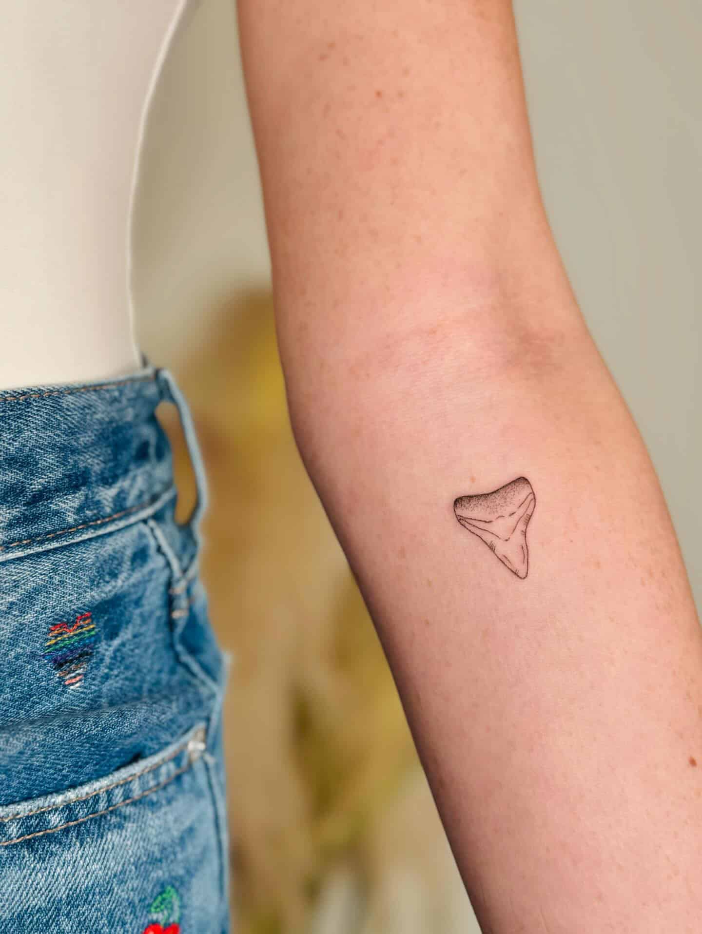 small shark tooth tattoo